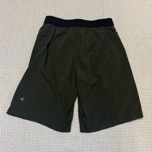 Lululemon Olive green athletic shorts featuring a zipper pocket.  Men’s medium.